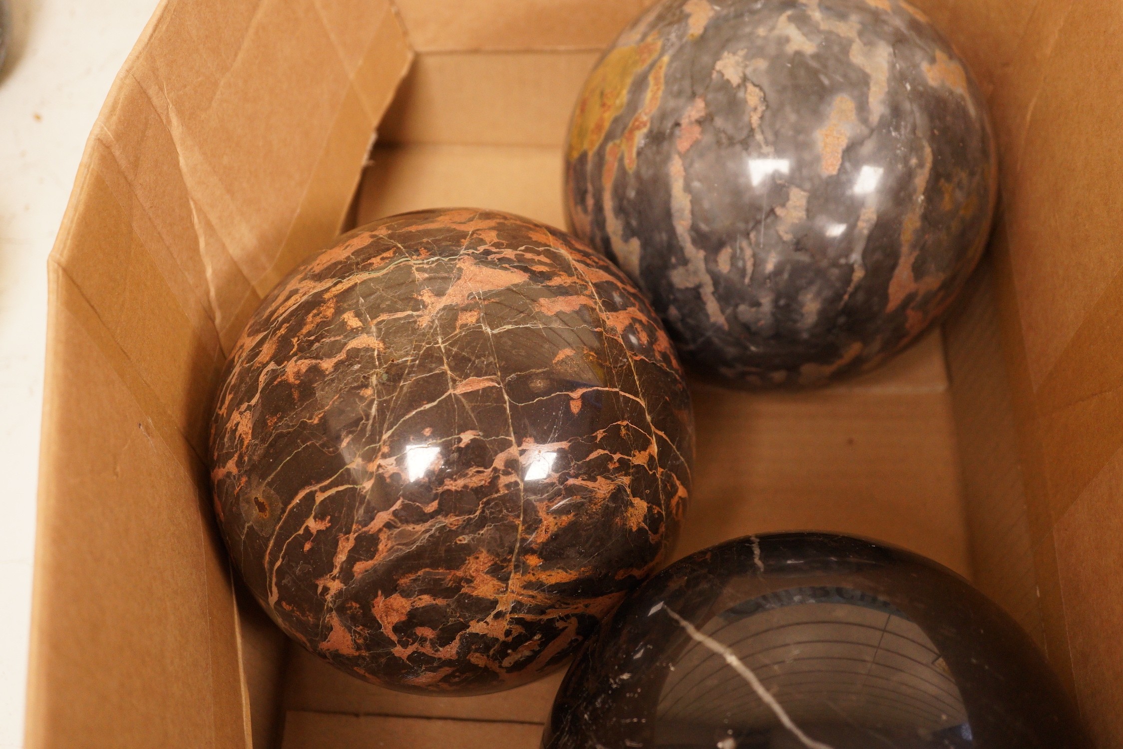 A trio of carved marble balls, largest 14.5cm